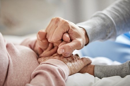 Two people holding hands across from each other